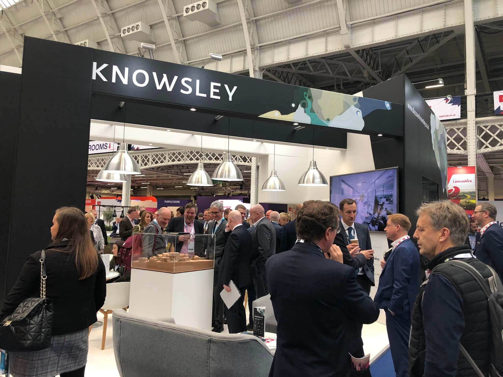 People talking at the MIPM exhibition